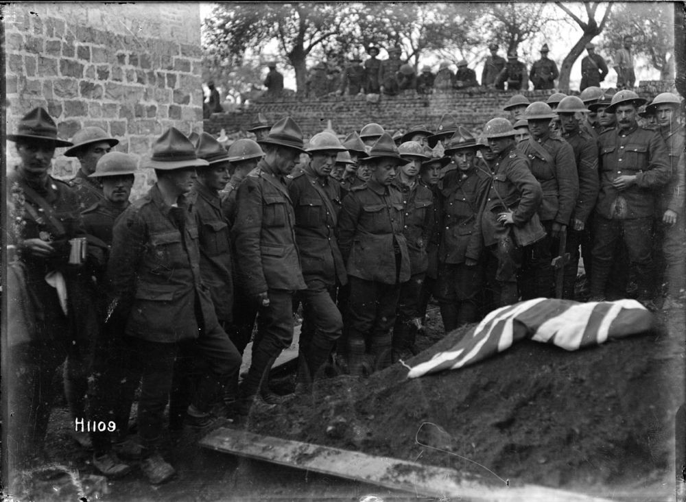 New Zealand soldiers gather at the grave of Sergeant Henry James Nicholas, VC, MM, France 9 November 1918.